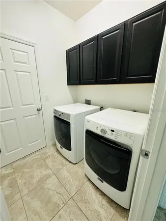 a view of a house with backyard porch and sitting area