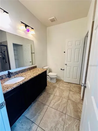 a bathroom with a glass door shower and a sink