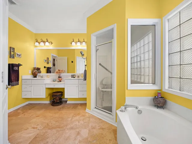 a bathroom with a tub sink and a large mirror