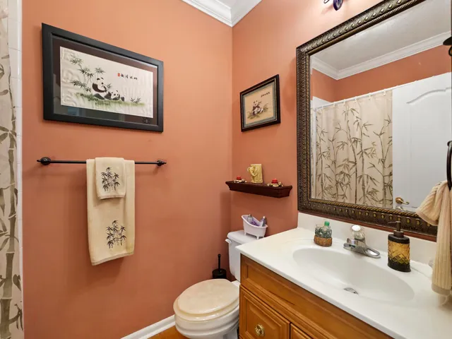 a bathroom with a toilet a sink and a mirror