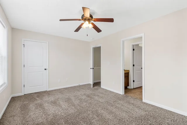 a view of a livingroom with a ceiling fan and entryway