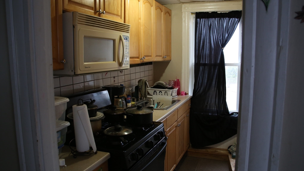 1951 Pleasant Street Fall River, MA 02723 - Photo 15 of 24 a kitchen with a sink and a stove top oven