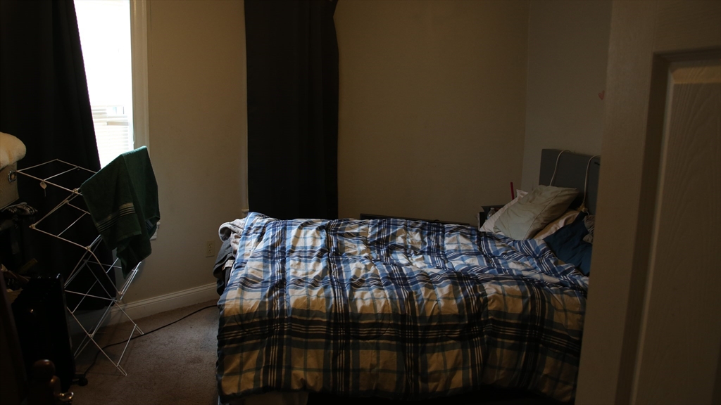 1951 Pleasant Street Fall River, MA 02723 - Photo 21 of 24 a bed sitting in a bedroom next to a window