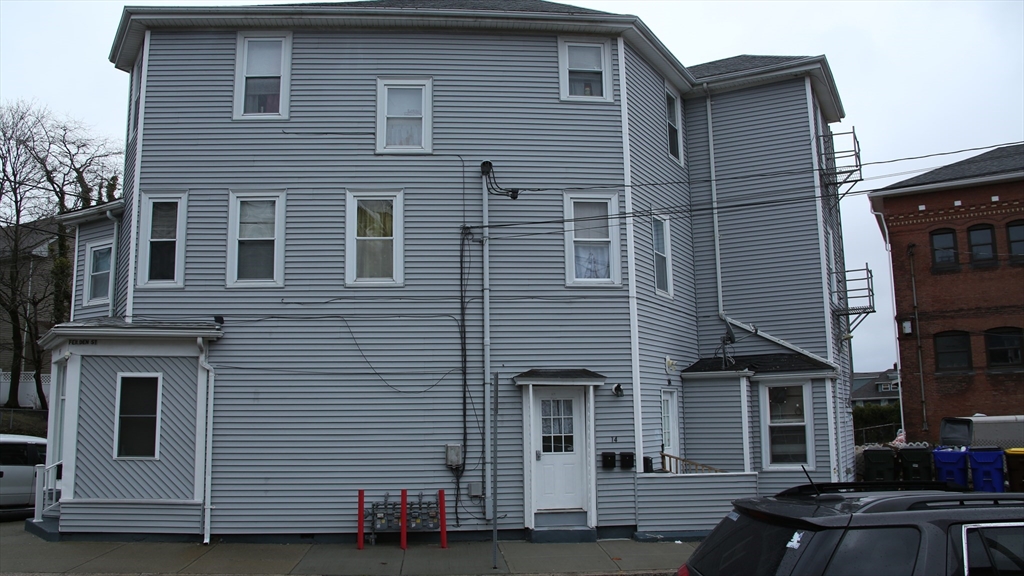 1951 Pleasant Street Fall River, MA 02723 - Photo 3 of 24 a front view of a house with a garage