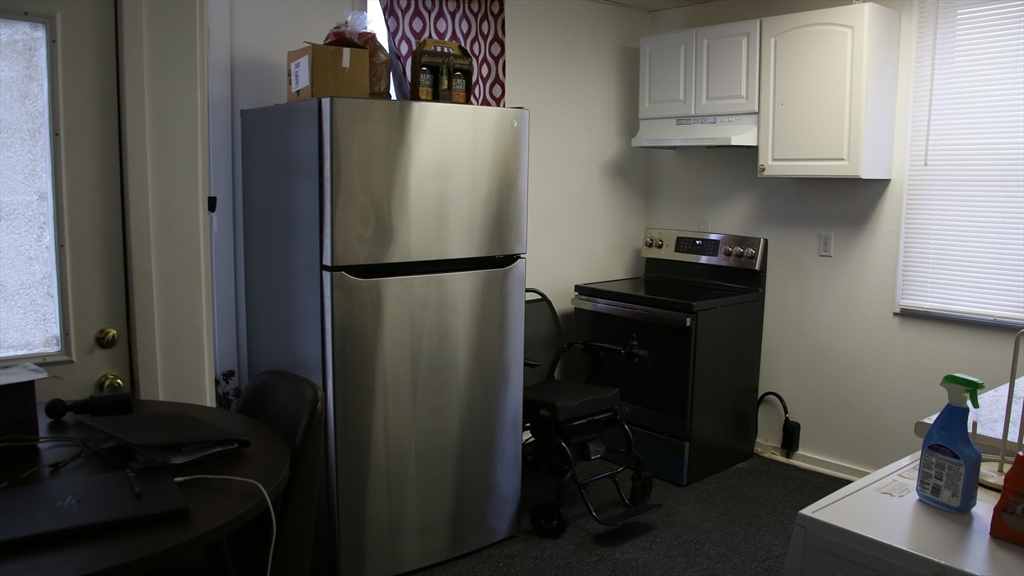 1951 Pleasant Street Fall River, MA 02723 - Photo 5 of 24 a kitchen with a refrigerator and cabinets