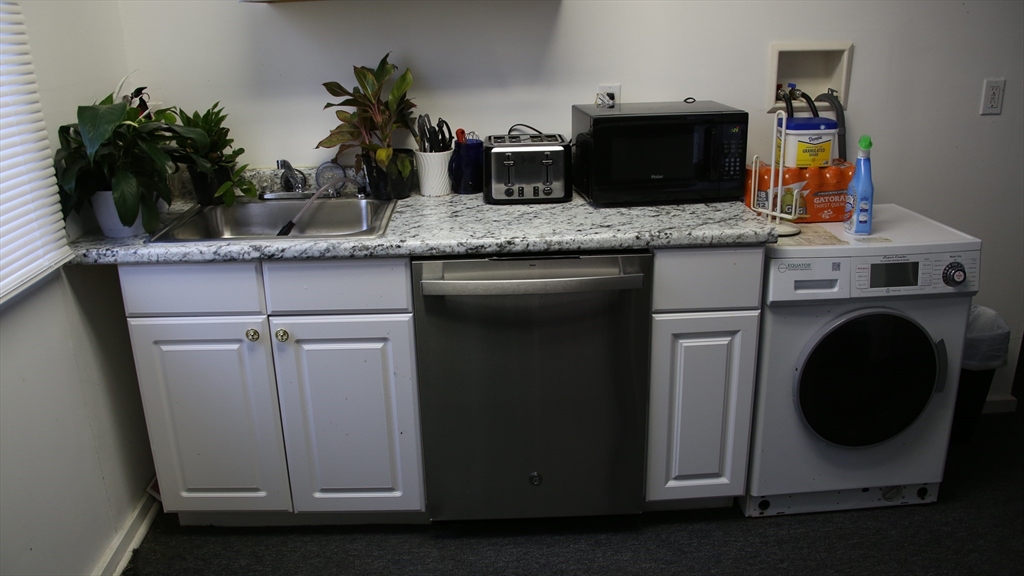 1951 Pleasant Street Fall River, MA 02723 - Photo 6 of 24 a kitchen with a sink and cabinets