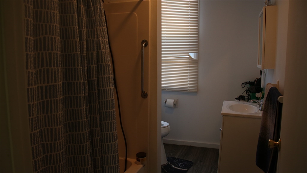 1951 Pleasant Street Fall River, MA 02723 - Photo 7 of 24 a bathroom with a shower and a sink
