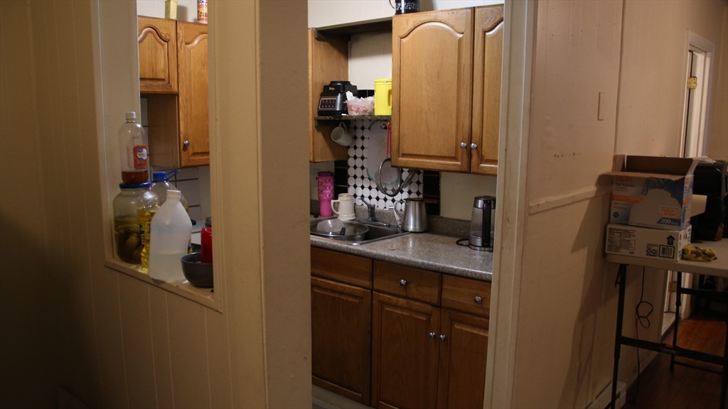 1951 Pleasant Street Fall River, MA 02723 - Photo 10 of 24 a bathroom with a mirror and cabinets