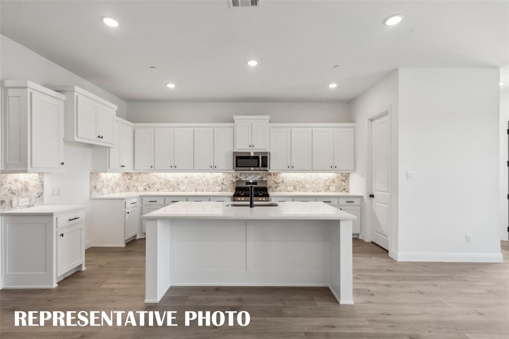 1331 Rooted Road Frisco, TX 75033 - Photo 6 of 14 The oversized kitchen island is the perfect place for friends and family to gather round. REPRESENTATIVE PHOTO