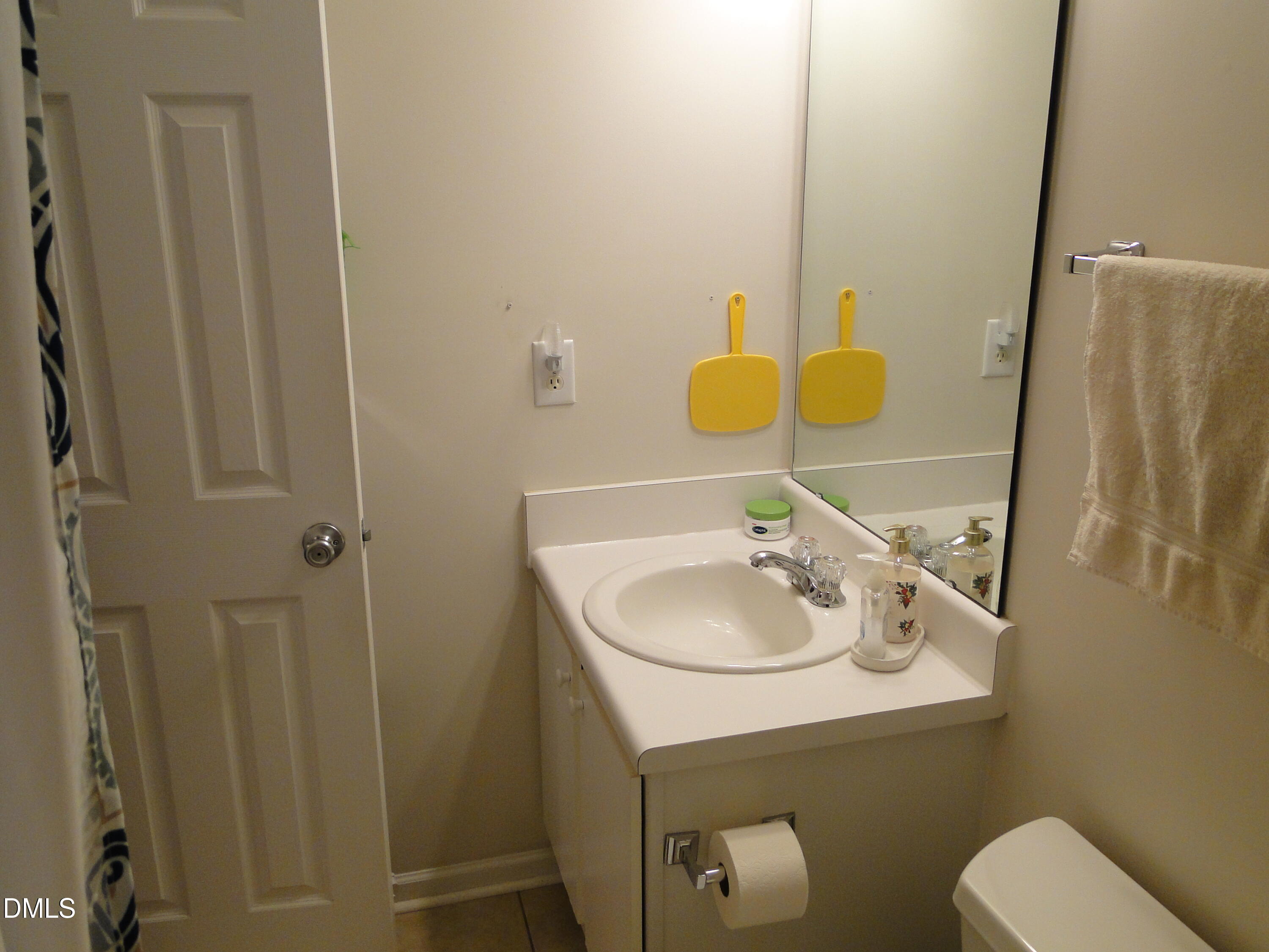5304 Marthonna Way Raleigh, NC 27616 - Photo 13 of 19 a bathroom with a sink toilet and a mirror