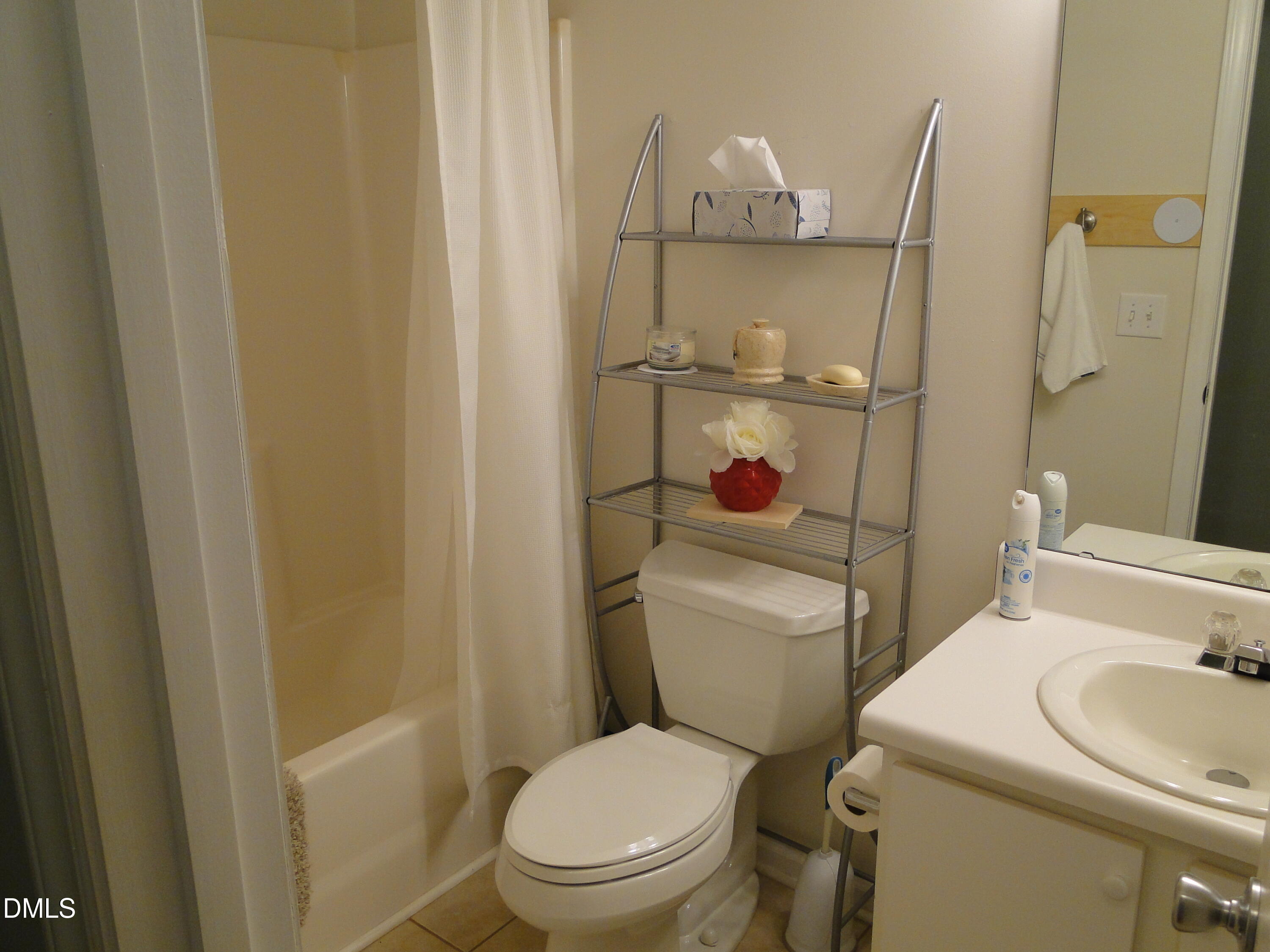 5304 Marthonna Way Raleigh, NC 27616 - Photo 15 of 19 a white toilet sitting next to a bathroom sink