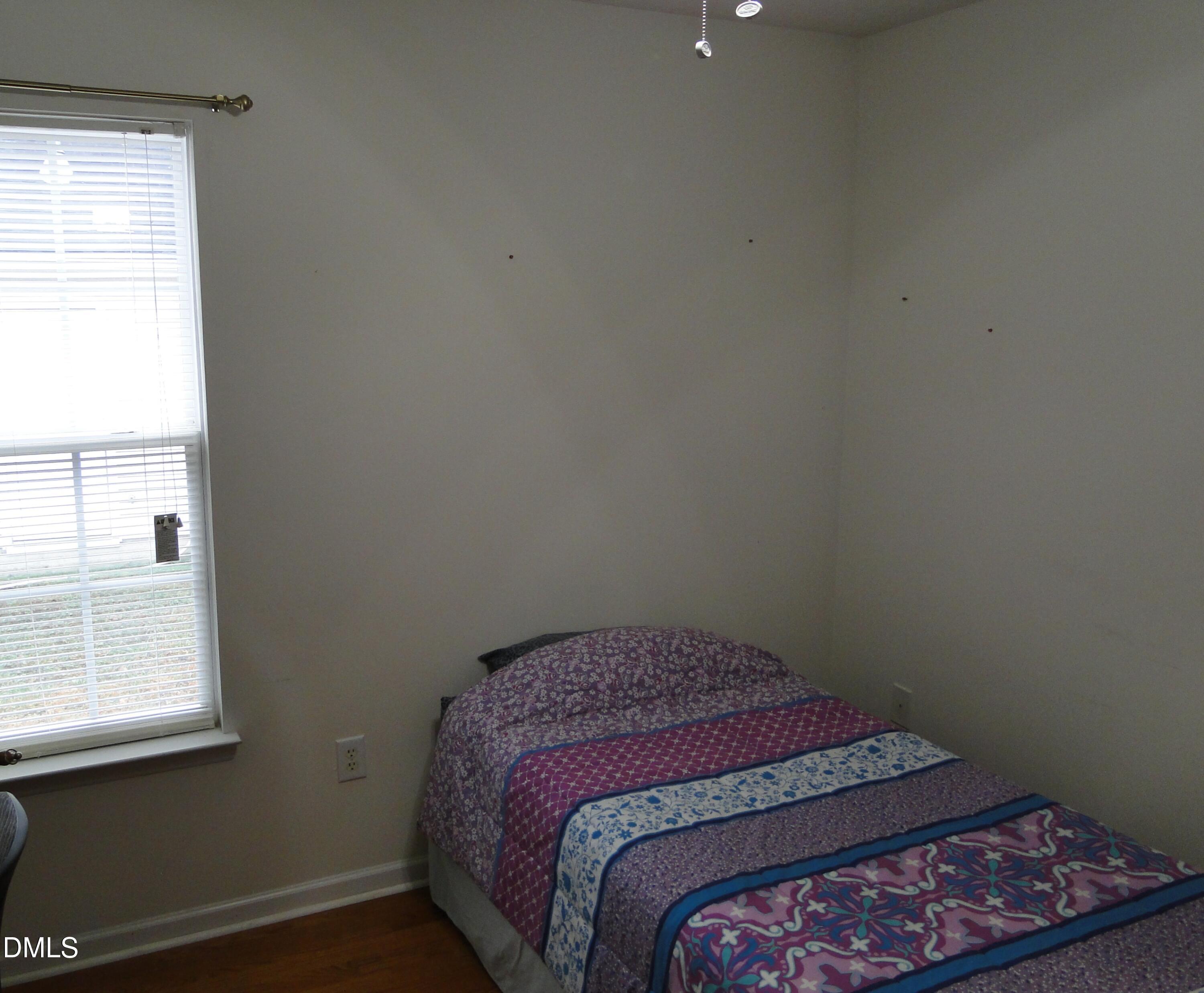 5304 Marthonna Way Raleigh, NC 27616 - Photo 16 of 19 a bedroom with a bed and a window
