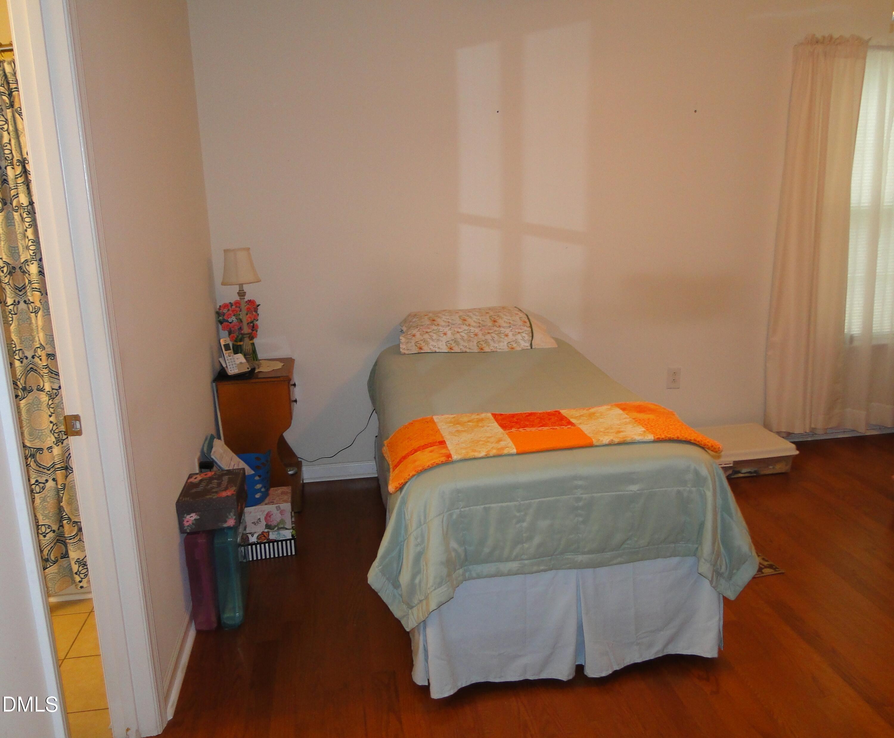 5304 Marthonna Way Raleigh, NC 27616 - Photo 10 of 19 a bedroom with a bed and wooden floor