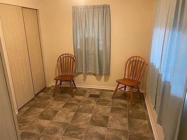 25225 Northeast 139th Street Salt Springs, FL 32134 - Photo 4 of 14 a living room with a chair and a rug