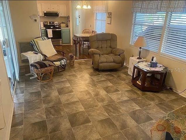 25225 Northeast 139th Street Salt Springs, FL 32134 - Photo 5 of 14 a living room with patio furniture and a floor to ceiling window