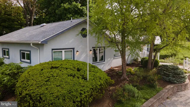 a view of a house with a yard and plants