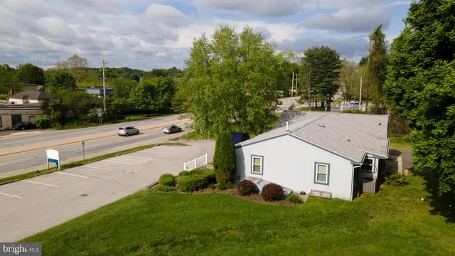 a view of a house with a yard and sitting area