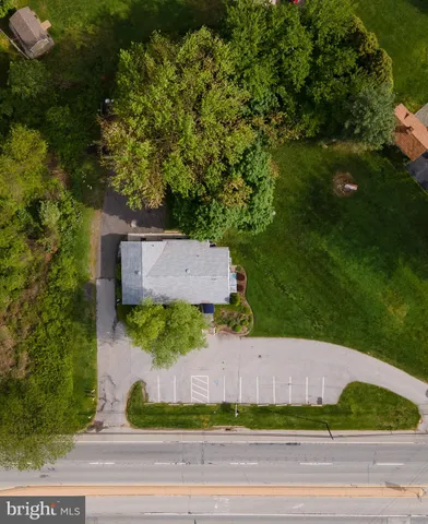 an aerial view of a house with yard
