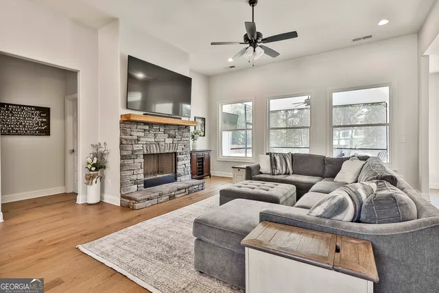 a living room with furniture a flat screen tv and a fireplace