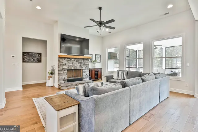 a living room with furniture fireplace and flat screen tv