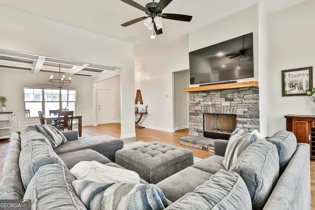 a living room with furniture a flat screen tv and a fireplace