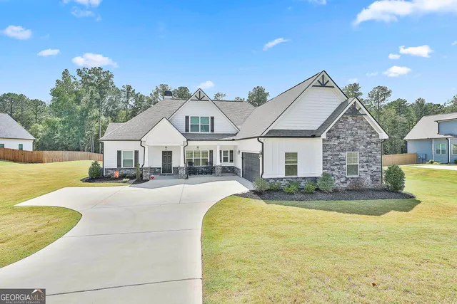 a front view of a house with swimming pool having outdoor seating