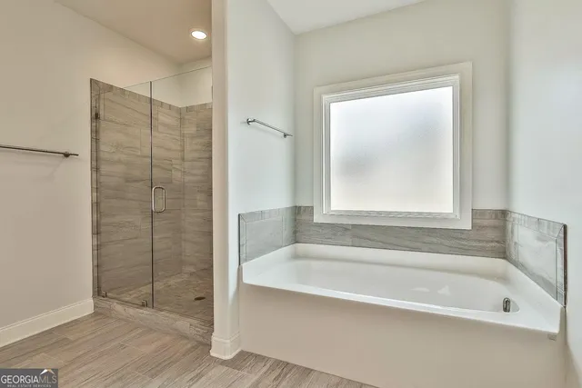 a bathroom with a bathtub and shower