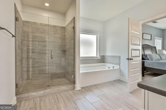 a bathroom with a bathtub and a shower