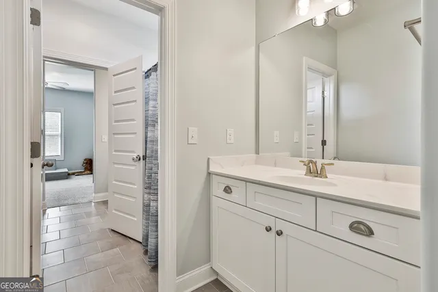 a spacious bathroom with a shower sink and mirror