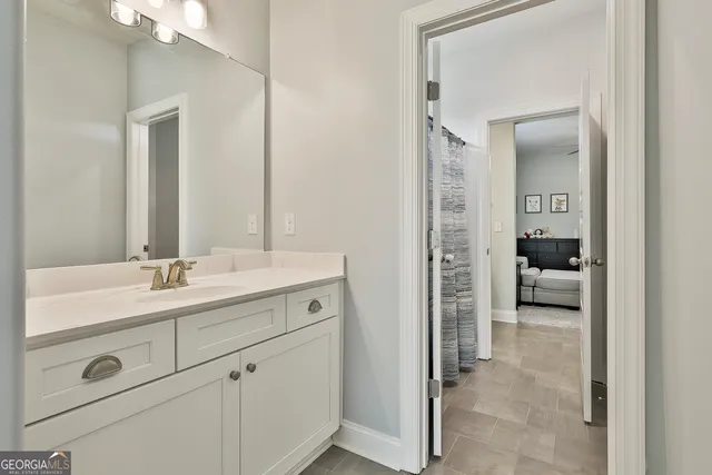 a en suite bathroom with a sink double vanity and a mirror