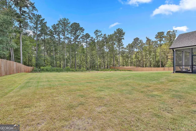 a view of a field with trees