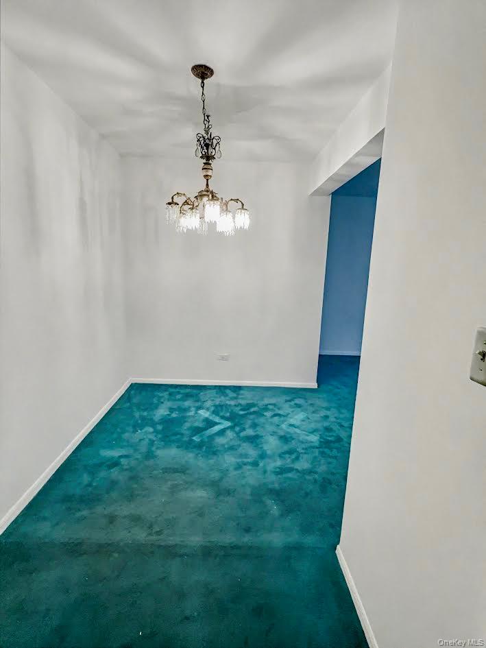 88-08 151st Avenue, Unit 3H Queens, NY 11414 - Photo 4 of 13 a view of a big room with a chandelier fan and wooden floor