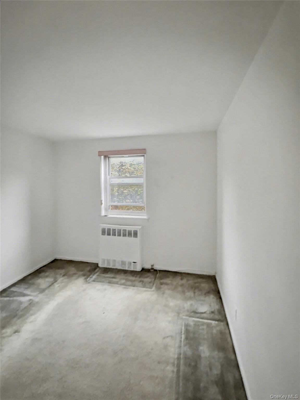88-08 151st Avenue, Unit 3H Queens, NY 11414 - Photo 9 of 13 an empty room with a empty space and windows