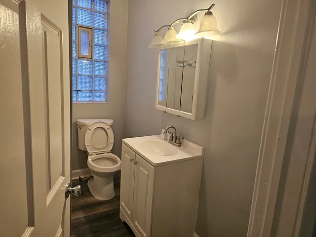 a bathroom with a sink a granite tub and shower