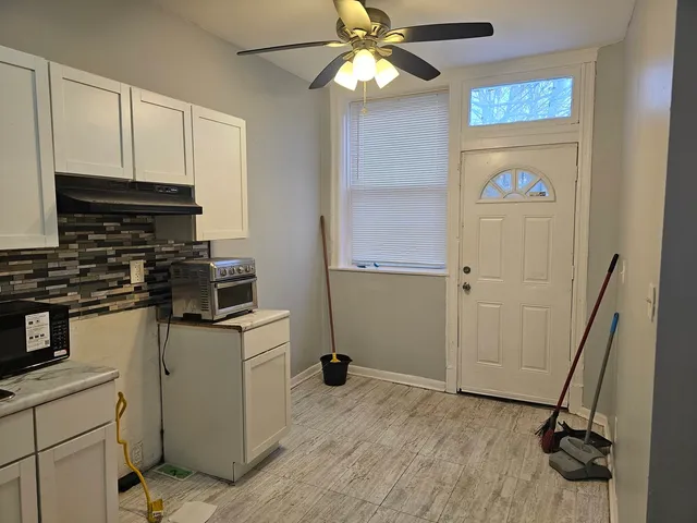 a kitchen with appliances a sink and cabinets
