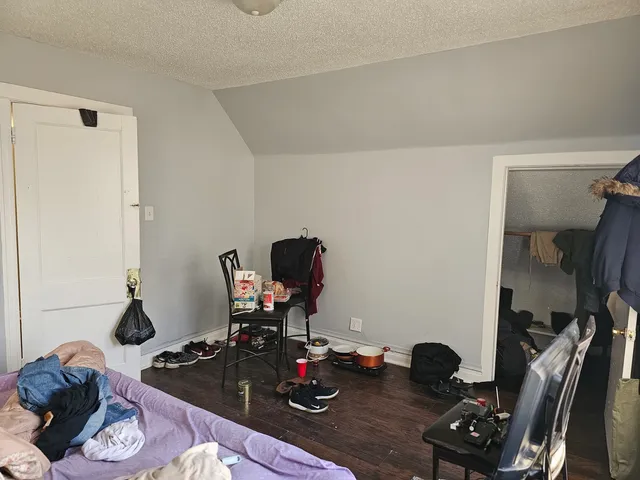 a view of a livingroom with wooden floor and a cabinet
