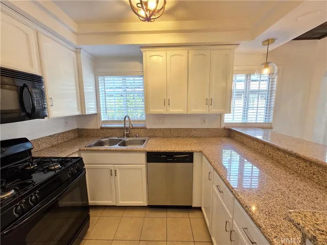 a kitchen with a stove a sink and a microwave