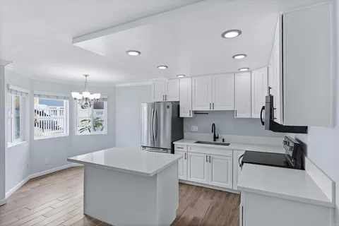 a kitchen with kitchen island a sink stainless steel appliances and cabinets