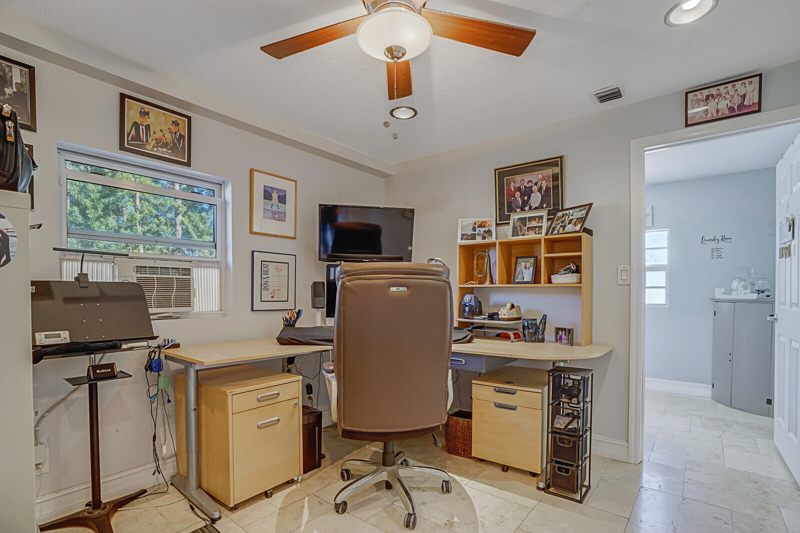8599 Cypress Springs Road Lake Worth, FL 33467 - Photo 27 of 59 a room with furniture and a flat screen tv