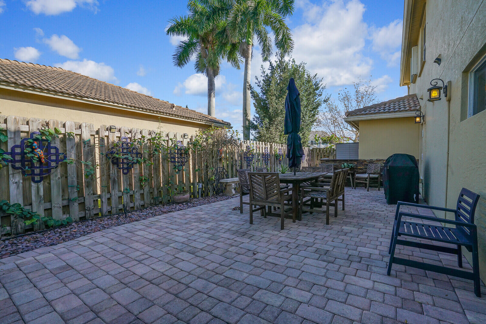 8599 Cypress Springs Road Lake Worth, FL 33467 - Photo 53 of 59 a view of a chairs and tables in the patio in front of a house