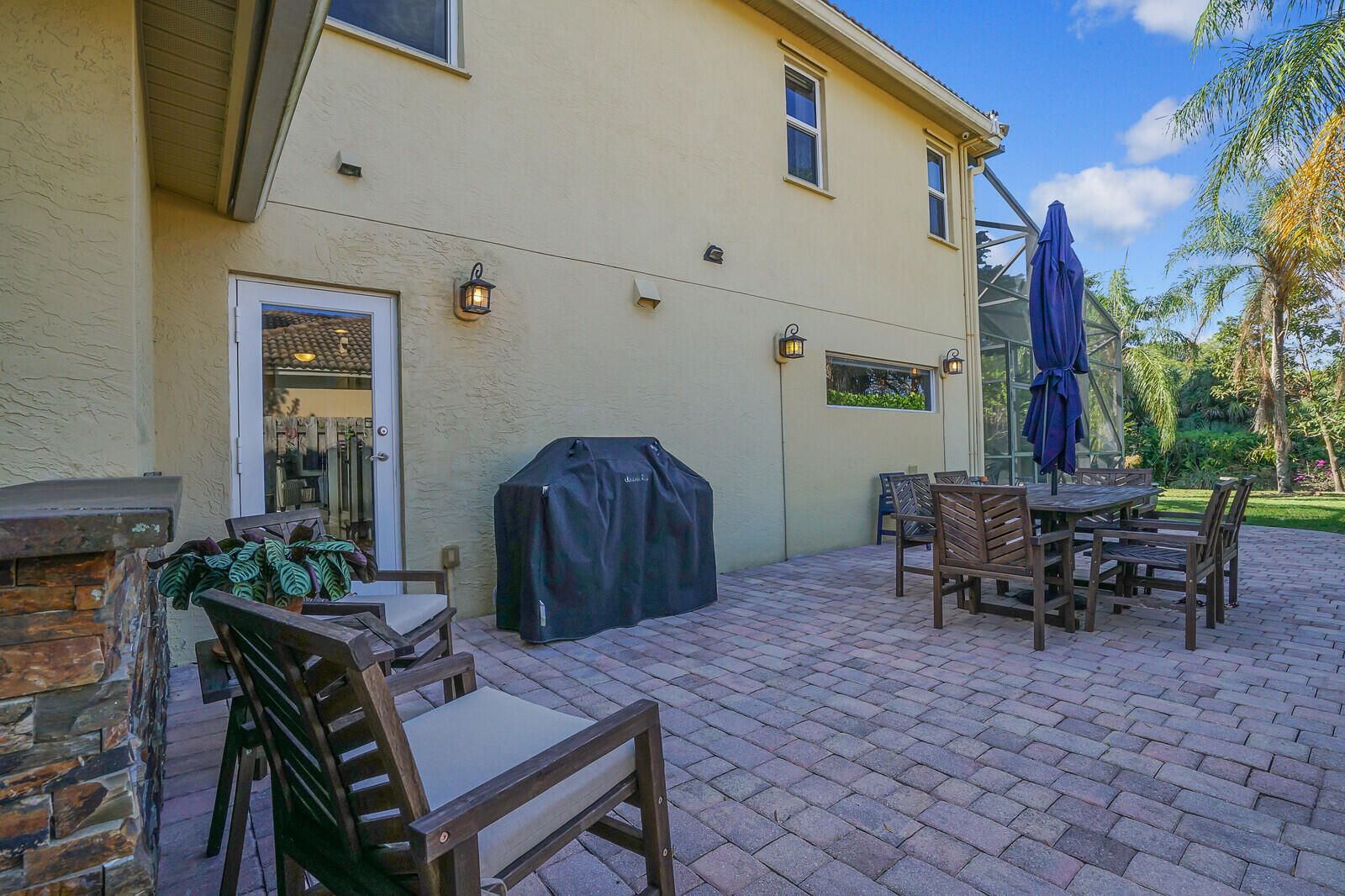 8599 Cypress Springs Road Lake Worth, FL 33467 - Photo 54 of 59 a view of a patio with table and chairs