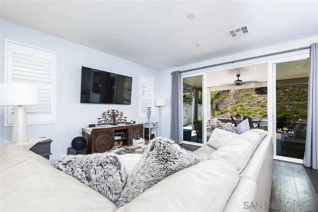 8828 Weston Road Santee, CA 92071 - Photo 13 of 25 a large bedroom with a large bed a flat screen tv and a large window