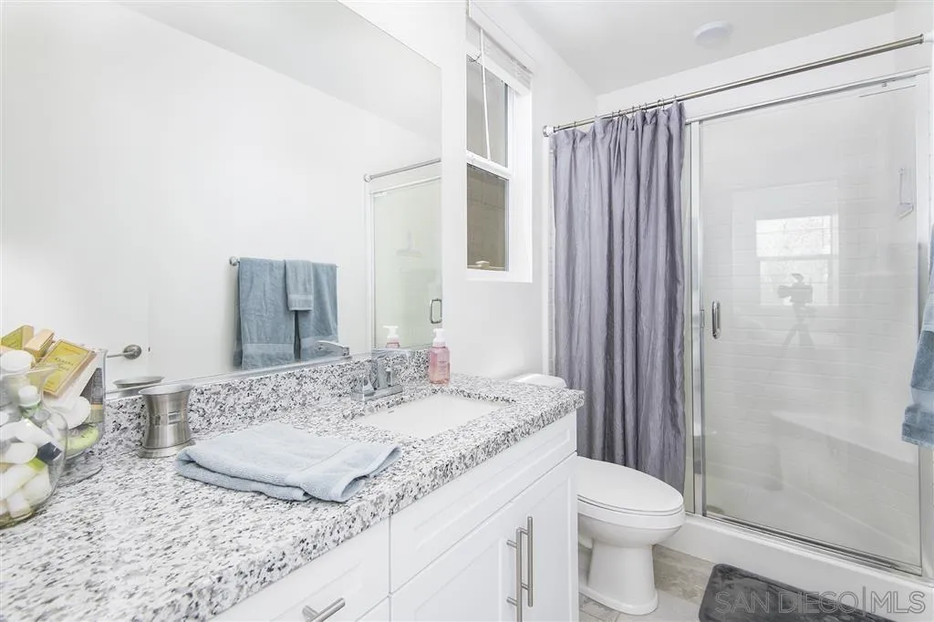 8828 Weston Road Santee, CA 92071 - Photo 16 of 25 a bathroom with a granite countertop sink and a mirror
