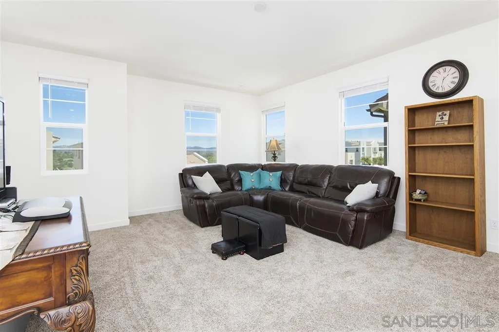 8828 Weston Road Santee, CA 92071 - Photo 18 of 25 a living room with furniture a window and cabinets