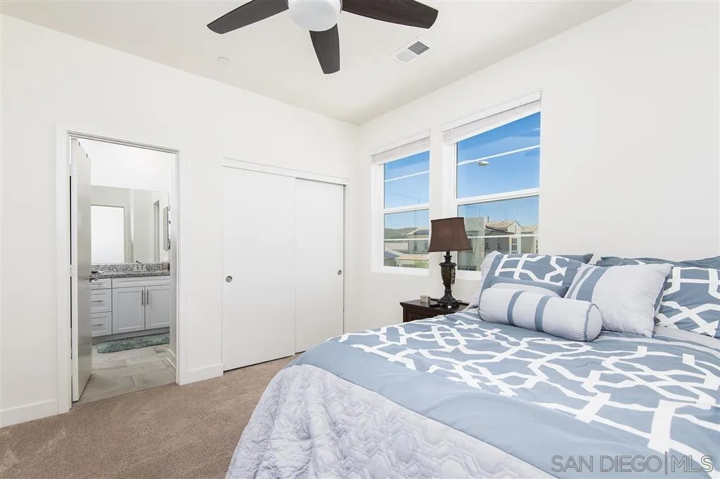 8828 Weston Road Santee, CA 92071 - Photo 19 of 25 a bedroom with a large bed and a chandelier
