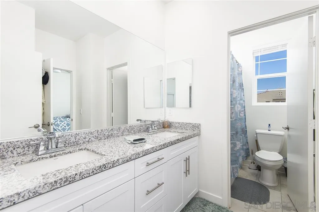 8828 Weston Road Santee, CA 92071 - Photo 21 of 25 a bathroom with a granite countertop sink mirror and toilet
