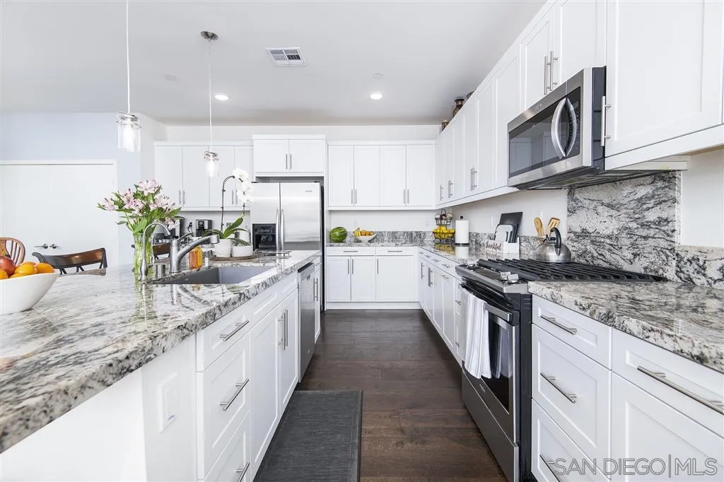 8828 Weston Road Santee, CA 92071 - Photo 5 of 25 a kitchen with stainless steel appliances granite countertop a sink stove and cabinets