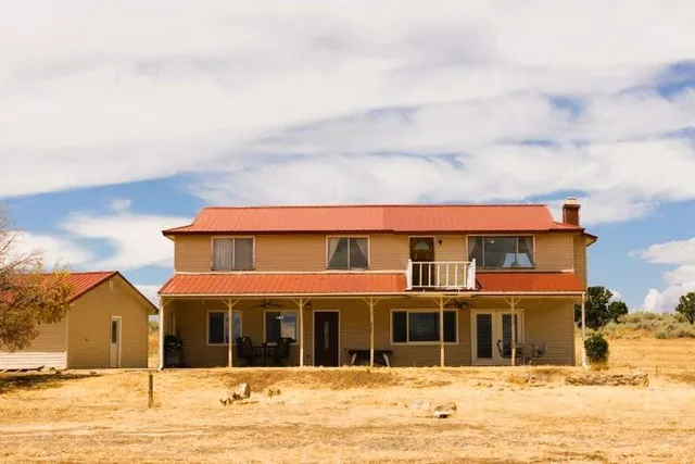 a view of a house with a snow on the road