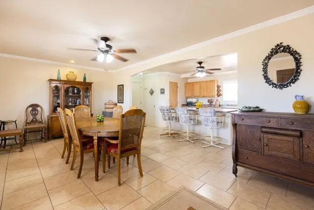 a kitchen with cabinets and chairs