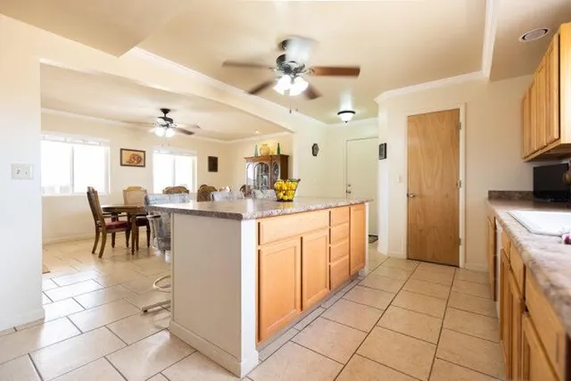 a large kitchen with stainless steel appliances lots of counter space and a sink